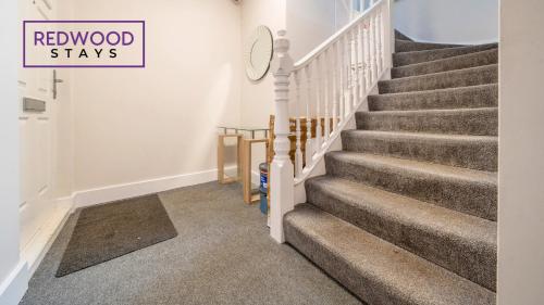 a winding staircase in a home with a carpet at Newly Refurbished Everest Lodge Serviced Apartments for Contractors & Families, FREE WiFi & Netflix by REDWOOD STAYS in Farnborough