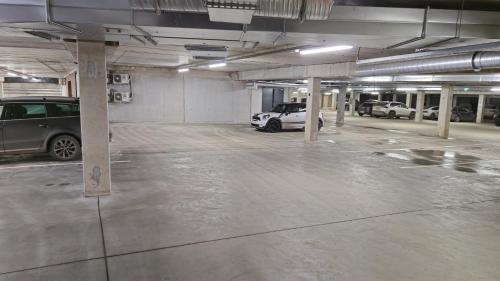 an empty parking garage with cars parked in it at Artisa Riia Str 22A Luxury apartment in Tartu