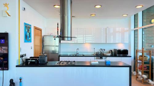 a kitchen with a counter top and a refrigerator at Oceanview 2BR Bliss in Al Raha - Pool & Balcony Near Al Raha Beach in Abu Dhabi