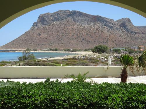 a view of a mountain from a room with a window at Blue Beach Villas Apartments in Stavros