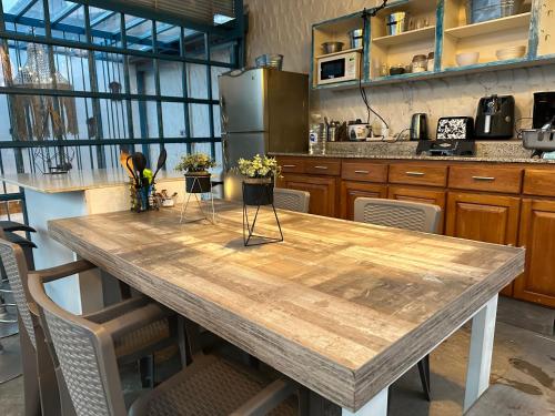 a kitchen with a wooden table in a kitchen at Hotel Casa Lucca in Medellín
