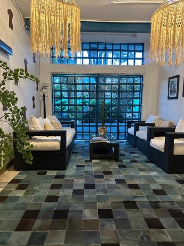 a living room with two couches and a checkered floor at Hotel Casa Lucca in Medellín