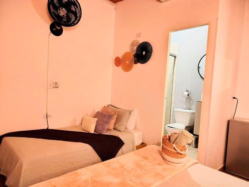 a bedroom with two beds and a mirror at Hotel Boutique Stay La 10 in Medellín