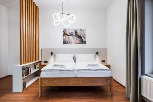 Postel nebo postele na pokoji v ubytování Maai Apartment