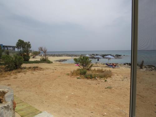 a view of a beach from a window at Blue Beach Villas Apartments in Stavros