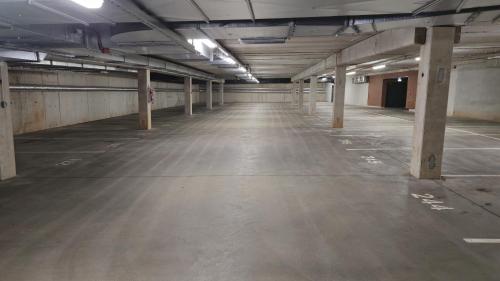 an empty parking lot in an empty parking garage at Artisa Riia Str 20a Luxury 2BR Penthouse Apartment in Tartu