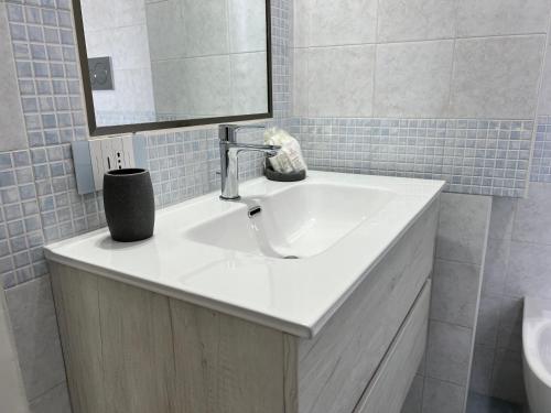 a bathroom with a white sink and a mirror at Pompei Sunday Estate Exclusive Apartaments in Pompei