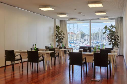 a restaurant with tables and chairs and a large window at Altis Belem Hotel & Spa, a Member of Design Hotels in Lisbon