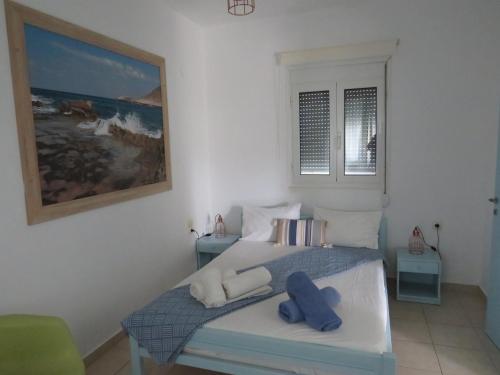a bedroom with a bed with two blue towels at Blue Beach Villas Apartments in Stavros