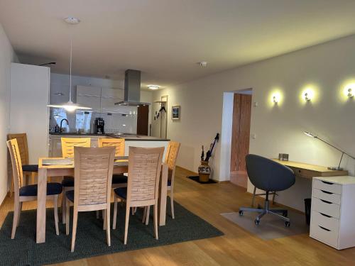 a kitchen and dining room with a table and chairs at Gipfelblick mit Hallenbad und Sauna in Bergen