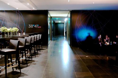 a restaurant with black walls and chairs and a bar at Altis Belem Hotel & Spa, a Member of Design Hotels in Lisbon