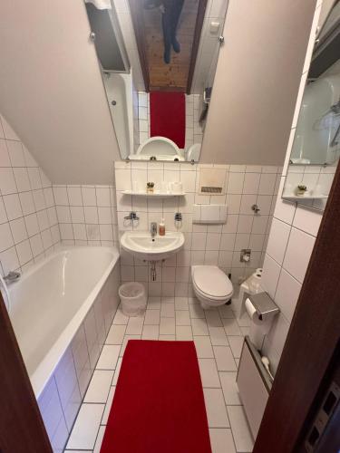 a bathroom with a tub and a toilet and a sink at Austria Traveller Hotel Kirchdorf in Kirchdorf an der Krems