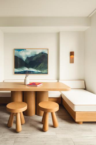 a room with a bench and a table and two stools at Flow Fort Lauderdale Hotel in Fort Lauderdale