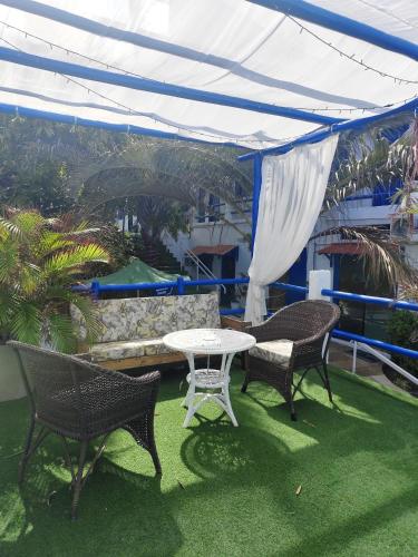 a patio with a table and chairs and a couch at Ponta Negra Suites & Apart in Natal