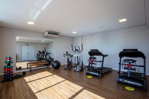 a gym with treadmills and exercise equipment in a room at Slaviero Rondonópolis Centro in Rondonópolis