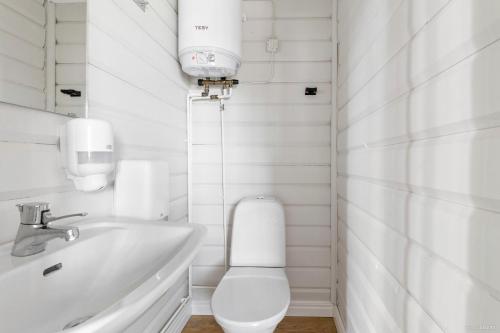 a white bathroom with a toilet and a sink at First Camp Fläsian - Sundsvall in Sundsvall