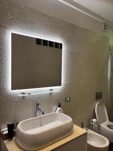 a bathroom with a sink and a toilet and a mirror at B & B Replay in Perugia