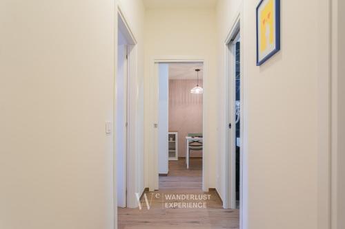 a hallway leading to a dining room with white walls at Wanderlust Experience Le dimore di Alice in Bitonto