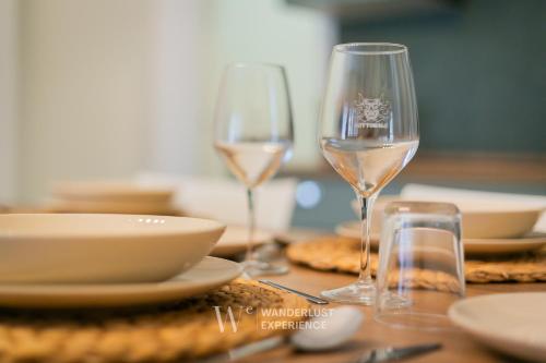 two glasses of white wine sitting on a table at Wanderlust Experience Le dimore di Alice in Bitonto