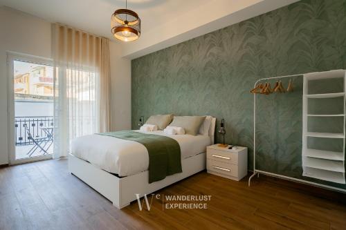 a bedroom with a bed and a green wall at Wanderlust Experience Le dimore di Alice in Bitonto