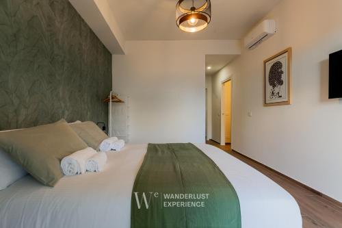 a bedroom with a bed with towels on it at Wanderlust Experience Le dimore di Alice in Bitonto