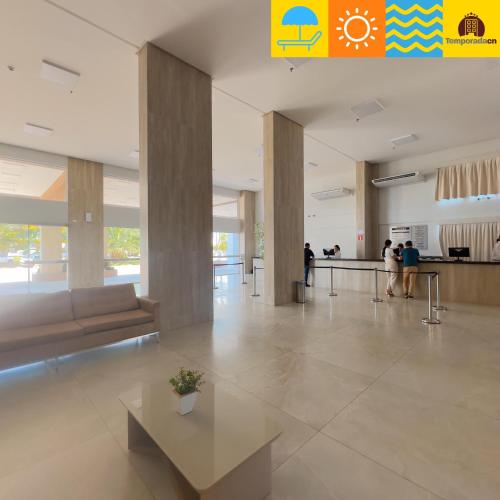 a lobby with people walking around in a building at Spazzio diRoma com acesso ao Acqua Park - Temporada CN in Caldas Novas