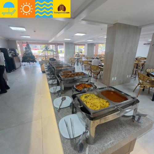 a buffet line with many different types of food at Spazzio diRoma com acesso ao Acqua Park - Temporada CN in Caldas Novas