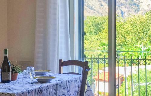 a table with a bottle of wine next to a window at Gorgeous Apartment In Trappitello in Trappitello