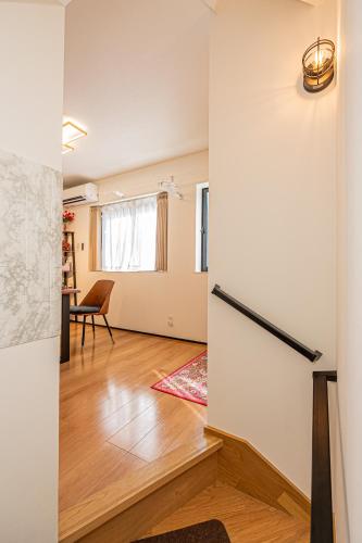 a living room with a door and a table at New 3-Story Japanese Villa, 5-Min Walk to Edogawa Sttion 7 Guests 76sqm Near Airport Kiyoka 清禾 in Tokyo