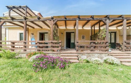 a house with a pergola and some flowers at Beautiful Apartment In Castellabate in Castellabate
