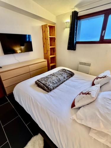 Ein Bett oder Betten in einem Zimmer der Unterkunft Les Aiguilles De Warens