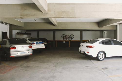 a garage with three cars parked in it at Hotel Pousada Del Rey in Macaé