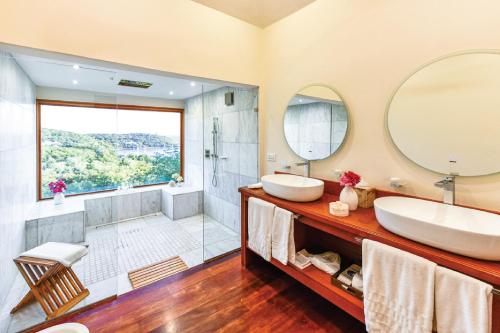 a bathroom with a tub and a sink and a shower at The Inn at English Harbour in English Harbour Town