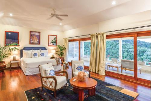 a bedroom with a bed and a table and chairs at The Inn at English Harbour in English Harbour Town