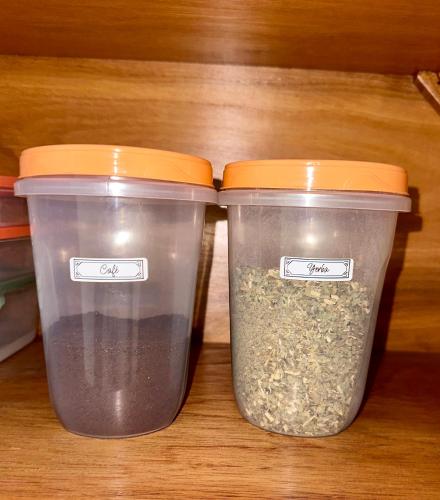 two plastic containers of food sitting on a shelf at Apartamento con piscina, terraza y parking en las cercanías de Asunción in San Lorenzo