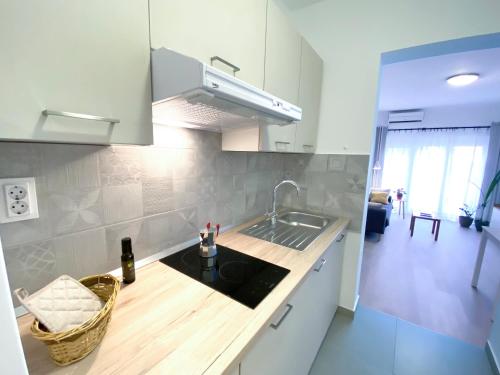 a kitchen with a sink and a counter top at Apartments TENA with Private Parking in Pula