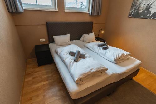 a bed with two pillows on it in a room at Landhaus Flasch in Wagrain