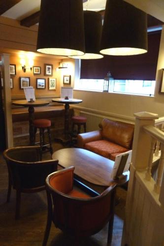 a living room with a couch and chairs and a table at Ye Olde Talbot Hotel by Greene King Inns in Worcester