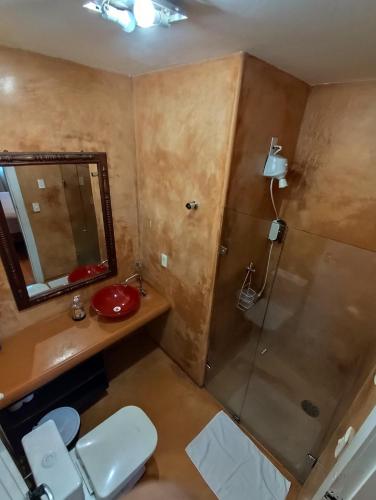 a bathroom with a toilet and a sink and a shower at Kabatukila Pousada in Natal