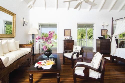 a living room with a couch and a table at The Inn at English Harbour in English Harbour Town