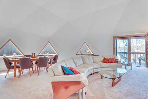 a living room with a couch and a table at Geodesic Dome House 18 Acres on Baraboo River! in Baraboo