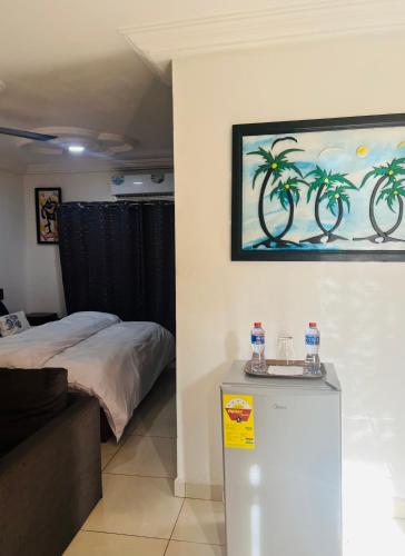 a bedroom with a bed and a painting on the wall at Beautiful place to stay in Accra in Accra