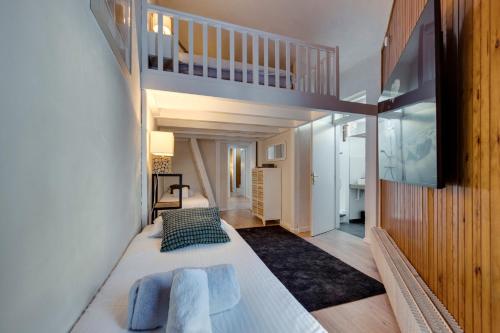 a bedroom with a large bed with blue pillows at Le Santel 199 in Val dʼIsère