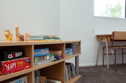 a book shelf filled with books in a room at Mount Hutt Haven in Methven