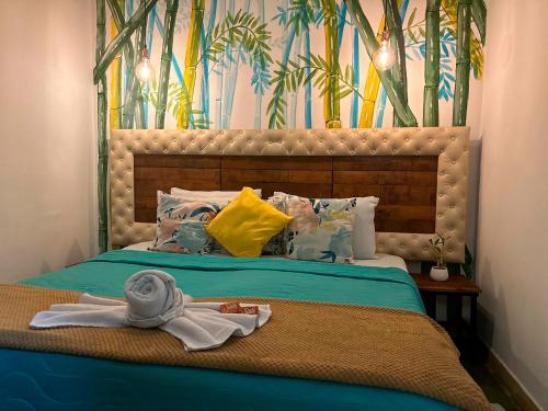 a bedroom with a bed with a towel on it at Hotel Boutique Stay La 10 in Medellín