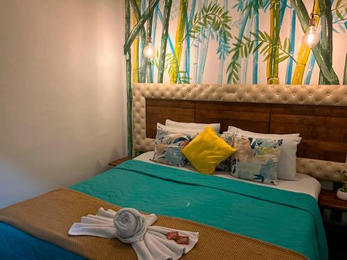 a bedroom with a bed with towels on it at Hotel Boutique Stay La 10 in Medellín