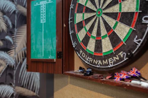 a dart board hanging on a wall with some darts at Mount Hutt Haven in Methven