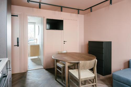 a small kitchen with a table and chairs in a room at New Apartment in Historical street in Bergen