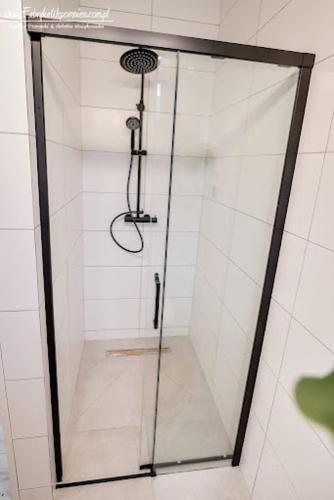 a shower with a glass door in a bathroom at PolanaKubicy,pl in Nowe Miasto