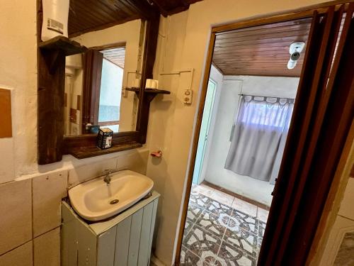a bathroom with a sink and a mirror and a window at Casa Río General Belgrano in General Belgrano